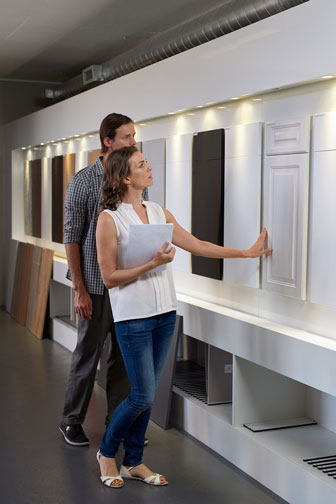 young couple choosing kitchen cabinet doors